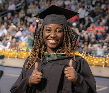 MC graduate showing thumbs-up