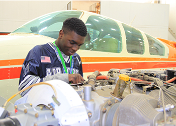 MC Student working on airplane engine