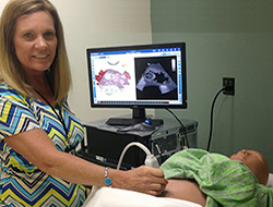 Instructor demonstrating a sonogram on a mannequin in the SimLife Center