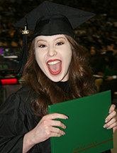 MC graduate celebrating diploma