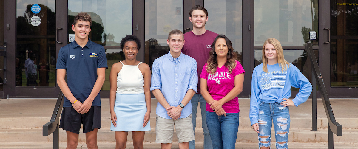 2019 Legacy Scholarship Recipients standing in front of the Library