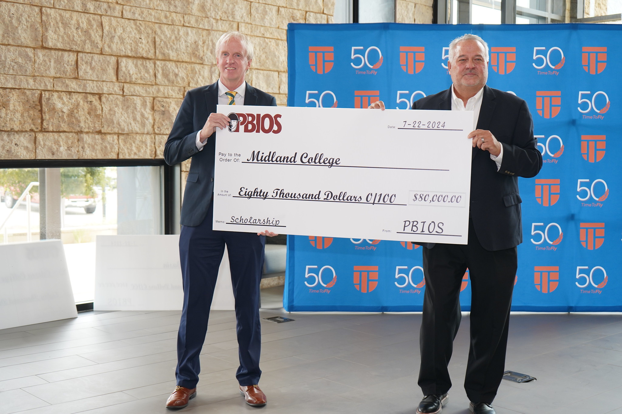 The image to use for this article. Listing image managed through RSS tab. MC Provost Michael Dixon poses with PBIOS president with donation check