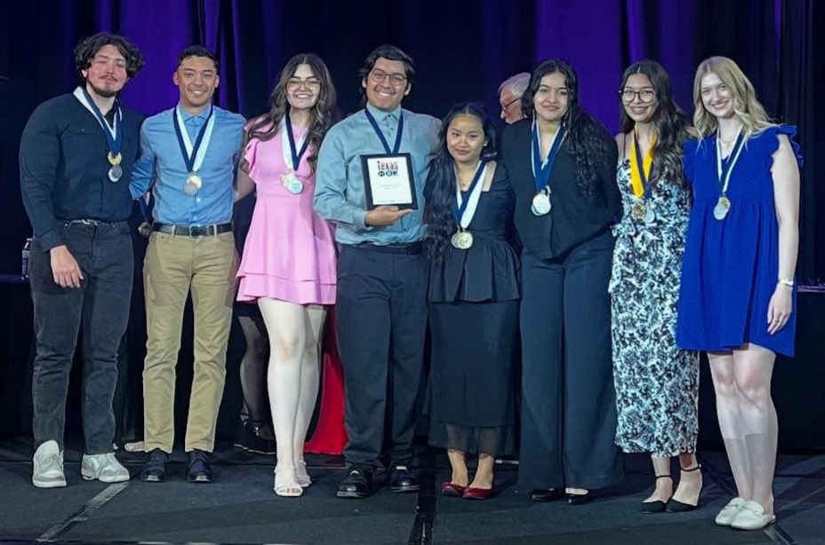 sptk students stand with their awards in hand