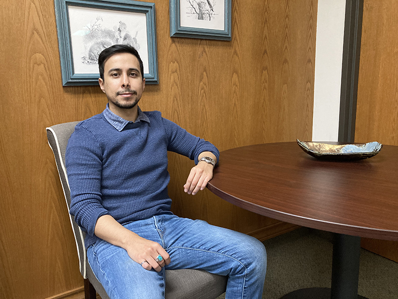 The image to use for this article. Listing image managed through RSS tab. Edwin Sigala sitting in chair at office table.